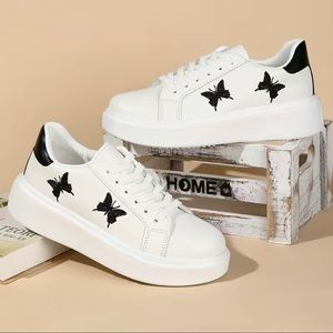 Woman’s white butterfly sneakers